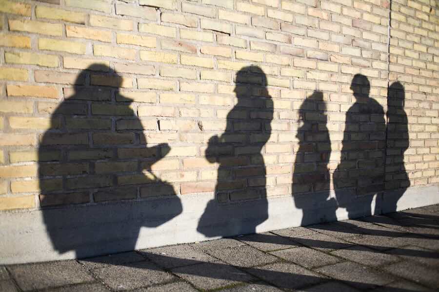 Shadow of high school students on wall outdoors