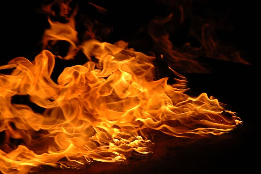 A flame going from left to right with a black background.